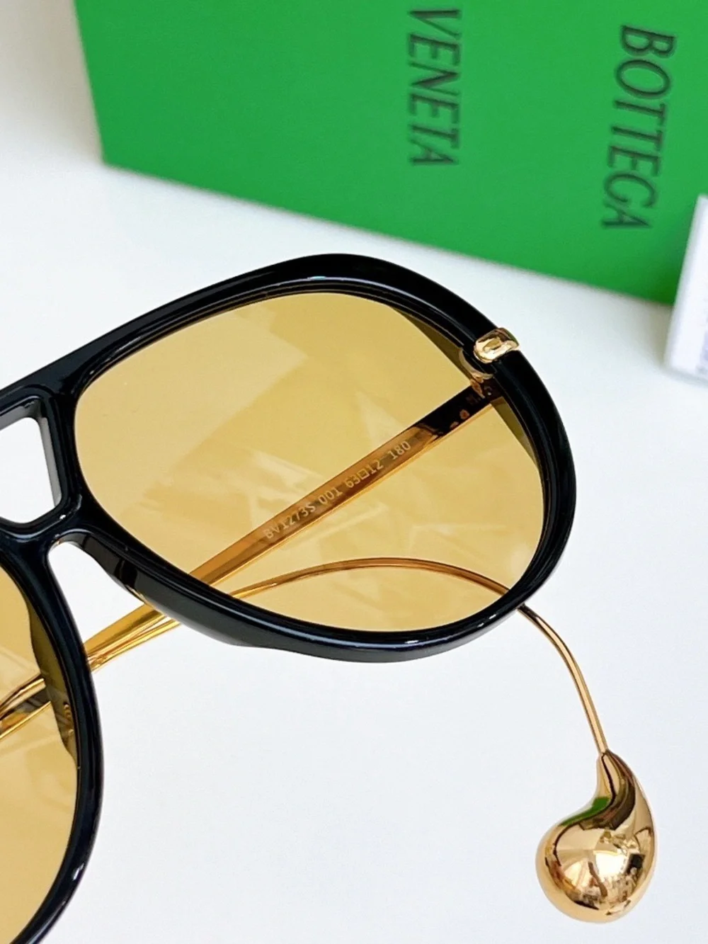 Bottega Veneta Black Frame Sunglasses with Amber Lenses and Gold Details
